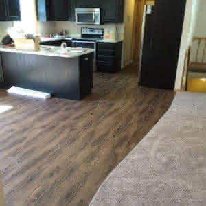 A wood floor kitchen with green walls