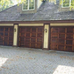 A house with three wooden garage doors