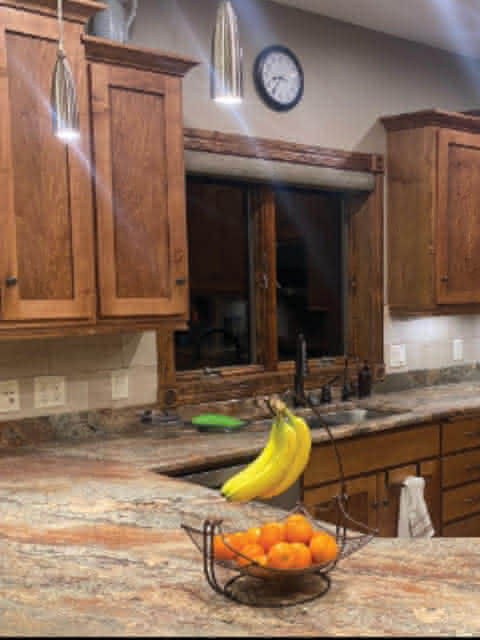 A kitchen with a granite counter